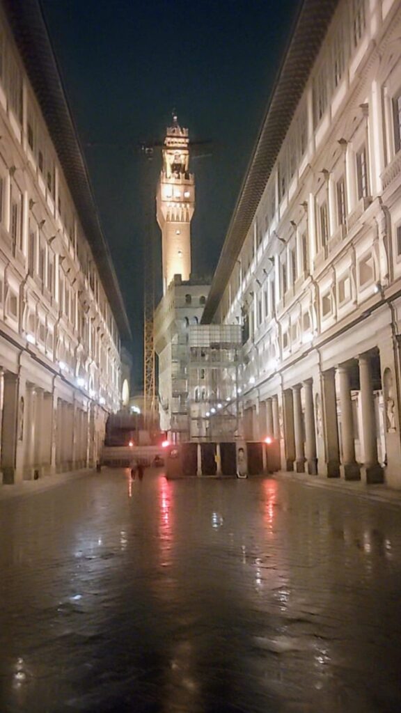 Uffizi on a wet evening showing reflections of lights on the wet floor 